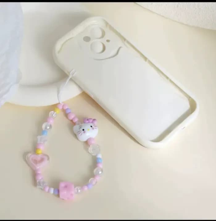 Cordon de téléphone Kawaii Hello Kitty avec nœud et perles pour appareil photo, accessoire de téléphone tendance pour fille 2026